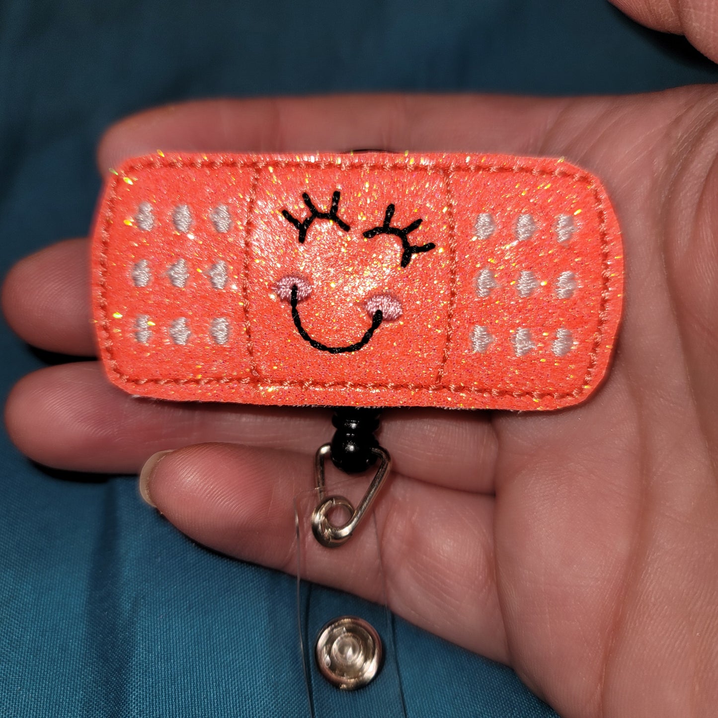 Bandaid Coral Glitter Badge Reel
